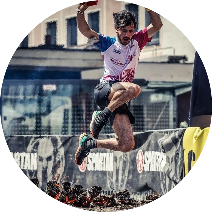 photo of a sporty person jumping over fire